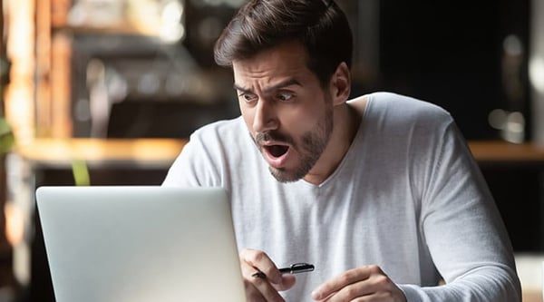 Shocked man in front of computer