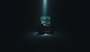 Hacker sitting in the dark room at the desk with a computer