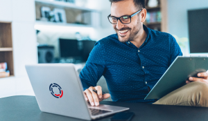 Man sitting in front of DriveLock's laptop in the office