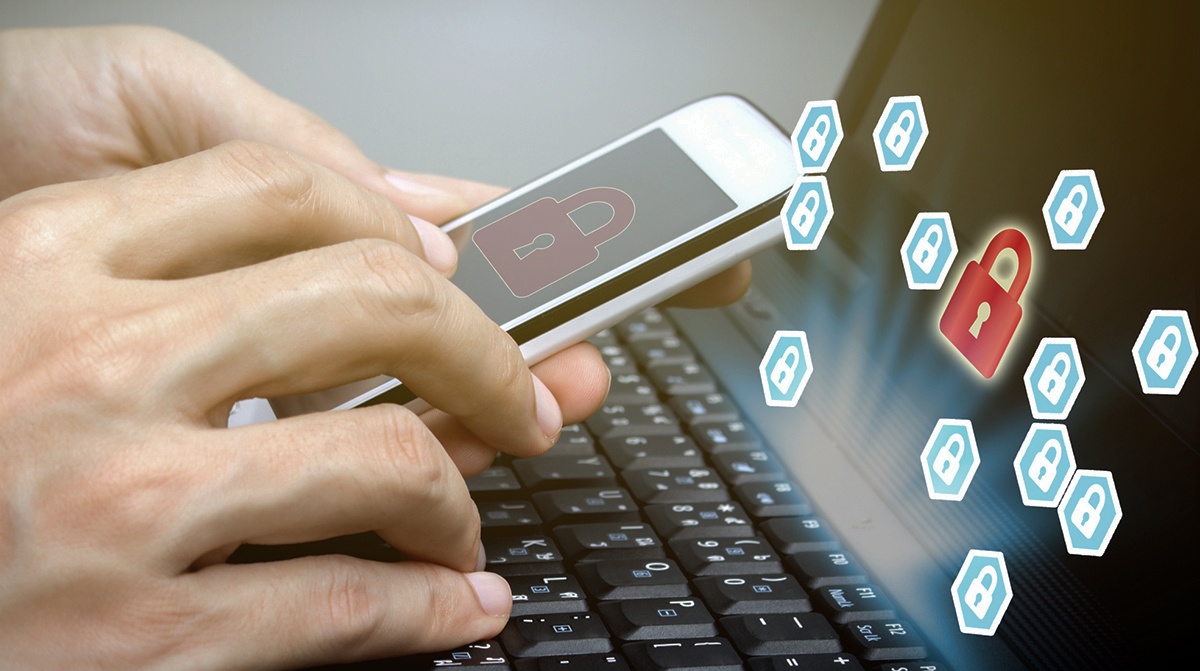 Mobile with Multi Factor Authentication in front of laptop