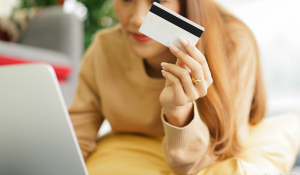 Woman doing Christmas online shopping by usage of credit card