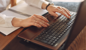 Woman writing on a keyboard