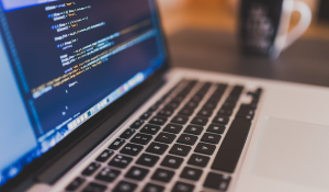 Laptop on the desk displaying a code