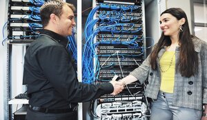 Two it engineers in network server room